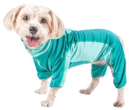 Dog wearing a teal onesie on a white background