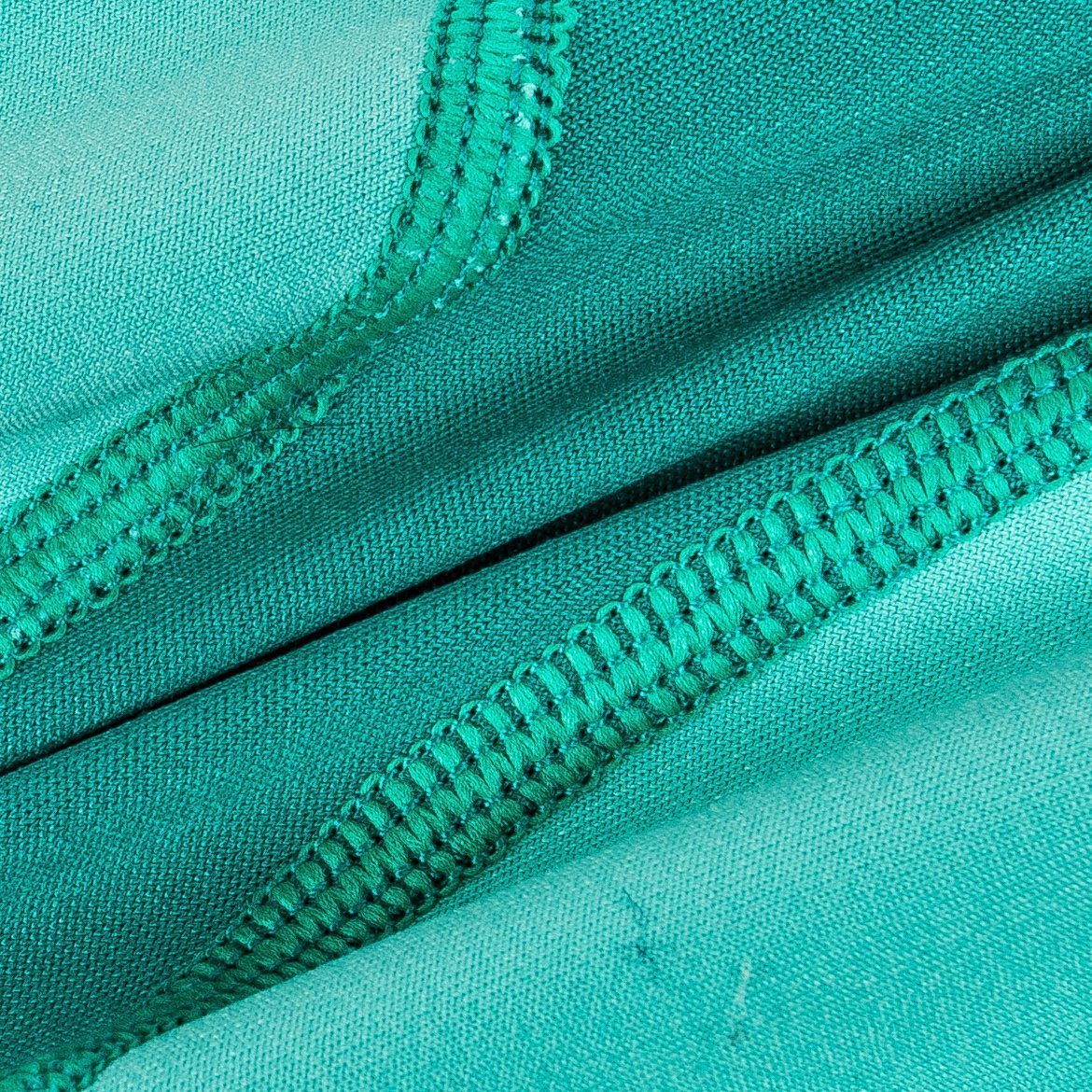 Close-up of teal fabric with a zipper