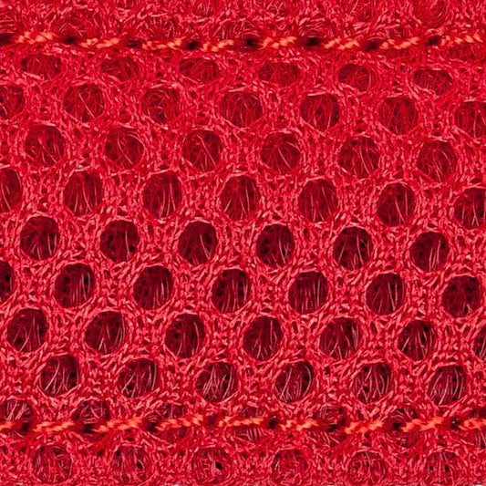 Close-up of red textured fabric with a honeycomb pattern