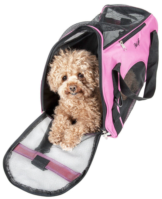 Small dog inside a pink and black pet carrier on a white background