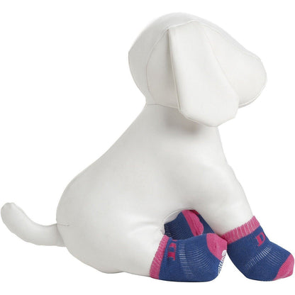 White dog figurine wearing blue and pink dog boots on a white background