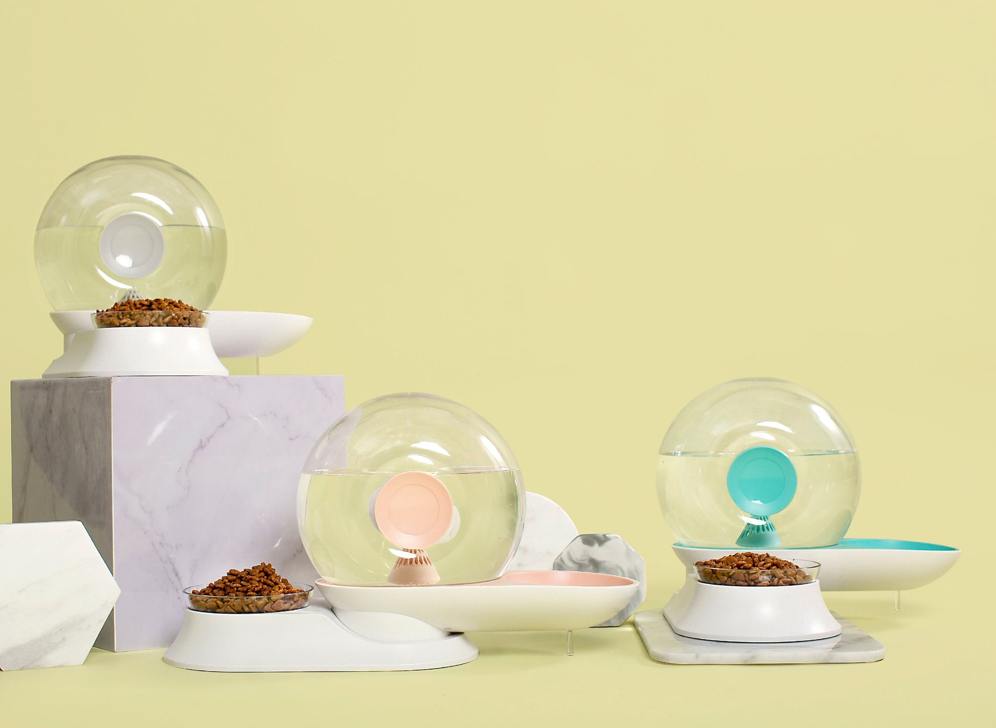 Decorative items including glass spheres and bowls on a light yellow background