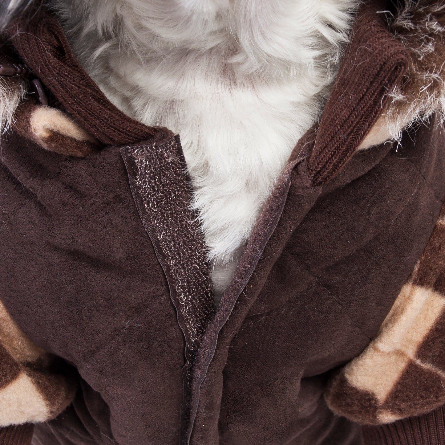 Close-up of a brown fabric with plaid pattern and white fluffy interior