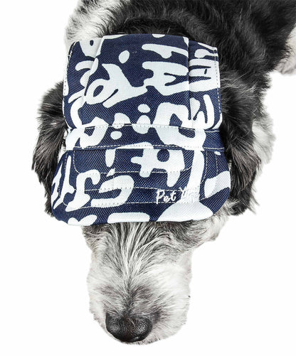 Dog wearing a navy blue and white patterned bandana on a white background
