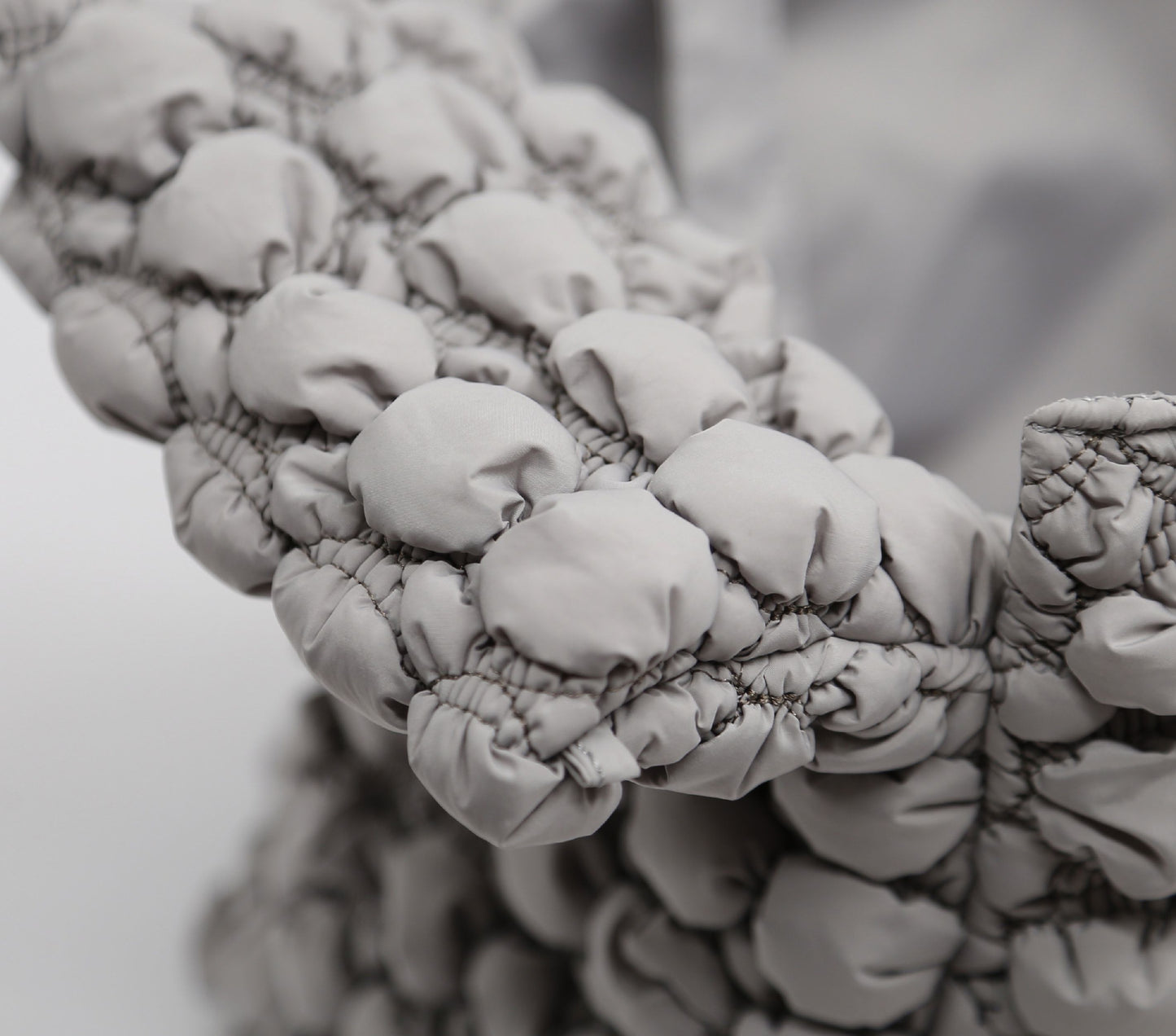 Close-up of a textured fabric surface with a blurred background