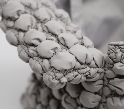 Close-up of a textured fabric surface with a blurred background