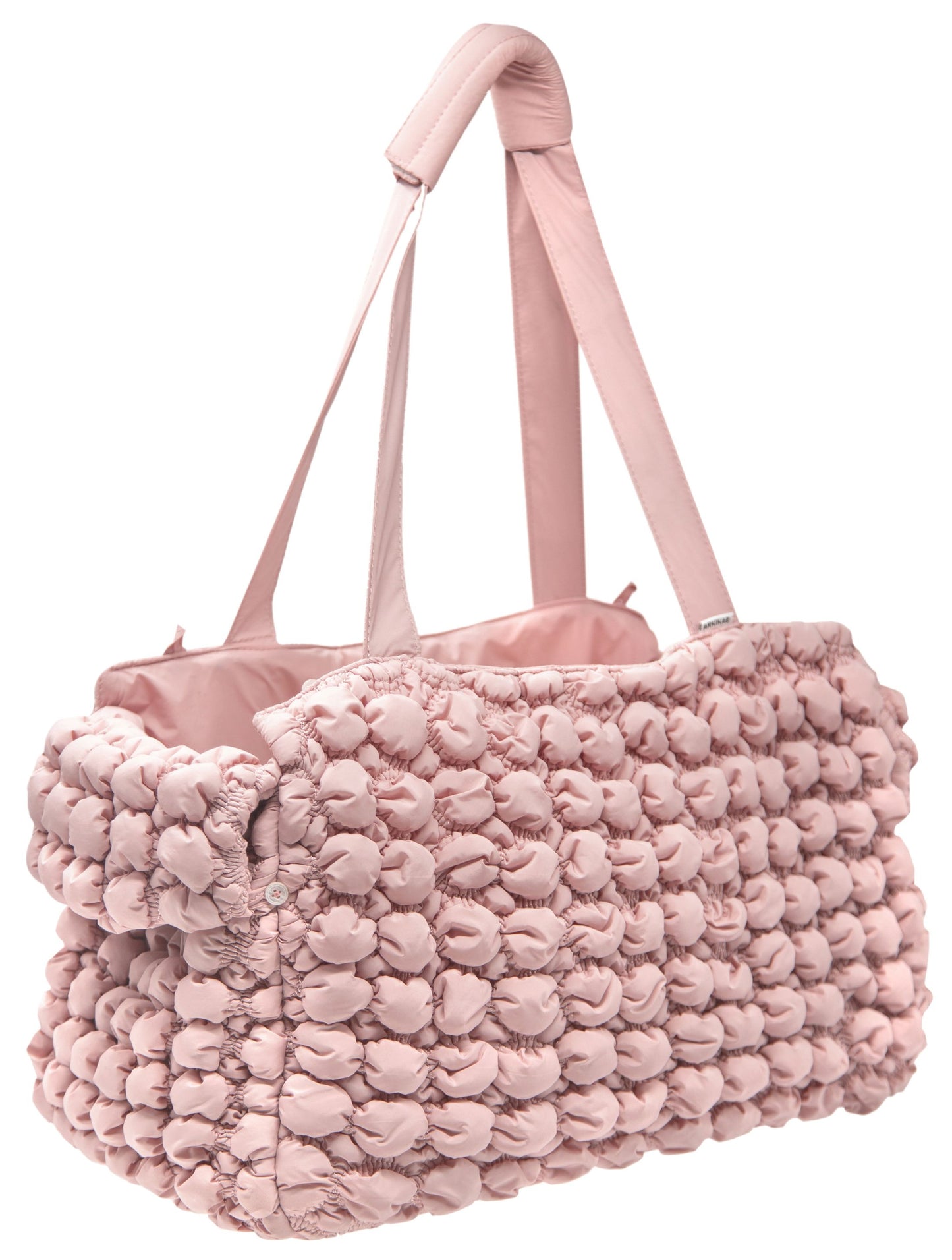 Pink textured bag with a matching handle on a white background