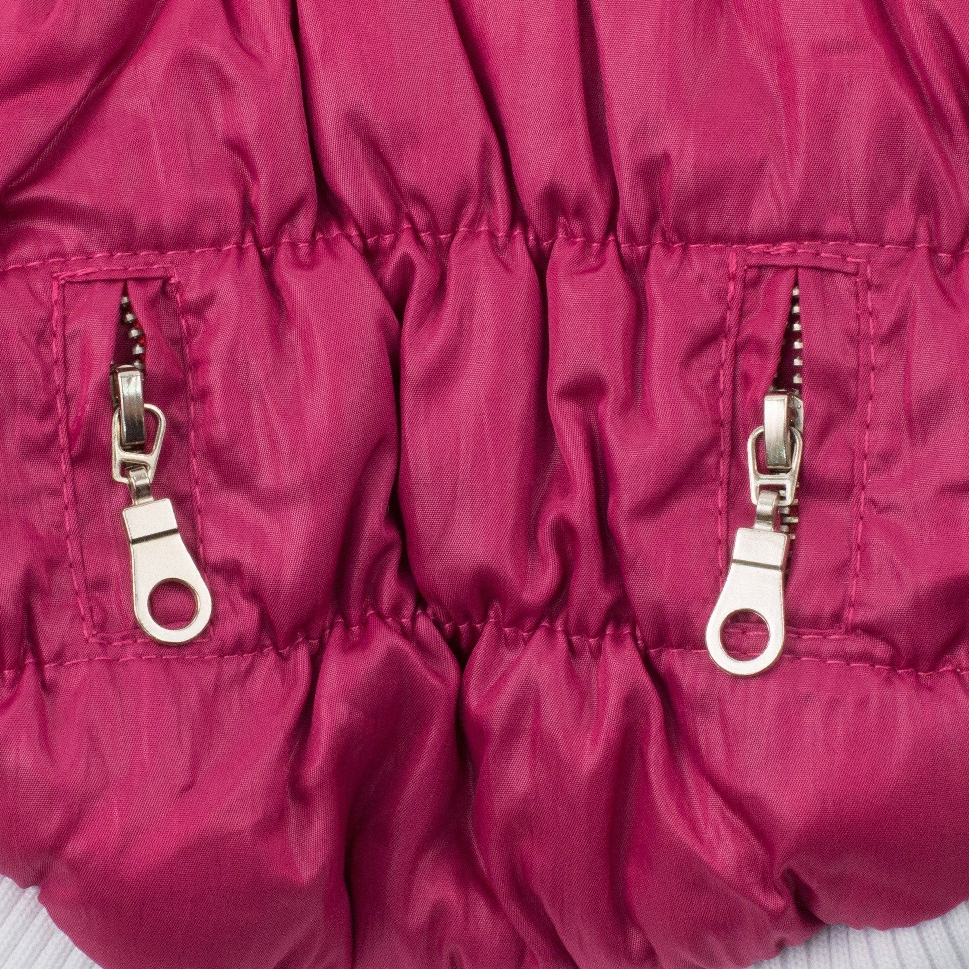 Close-up of a pink puffer jacket with zippers on a white background