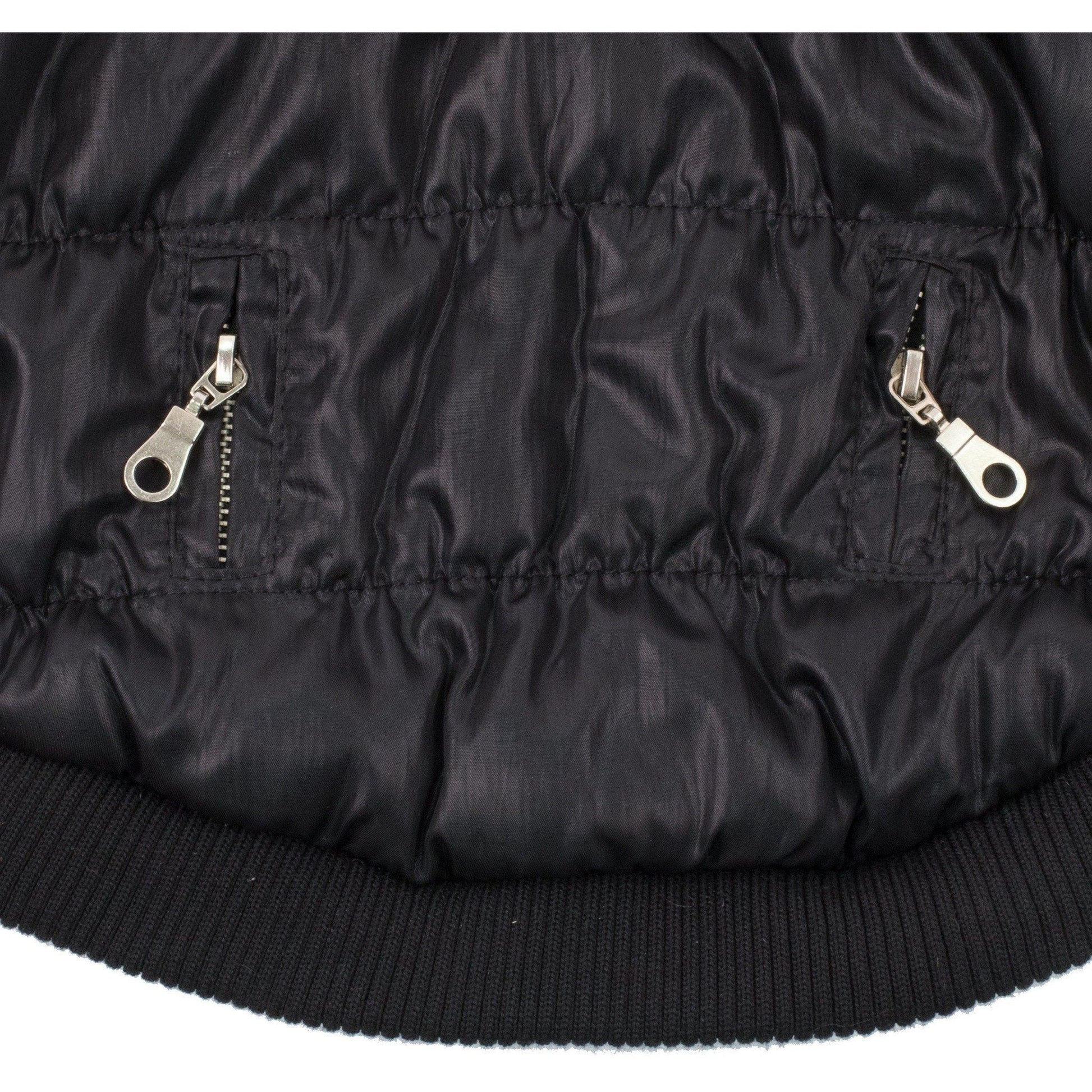 Close-up of a black puffer jacket with zippers on a white background