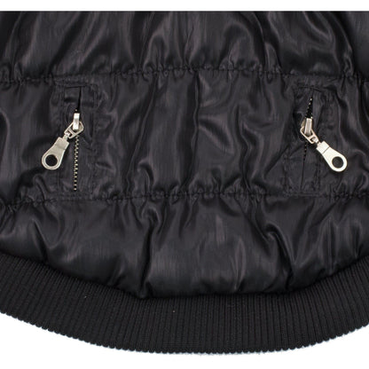 Close-up of a black puffer jacket with zippers on a white background