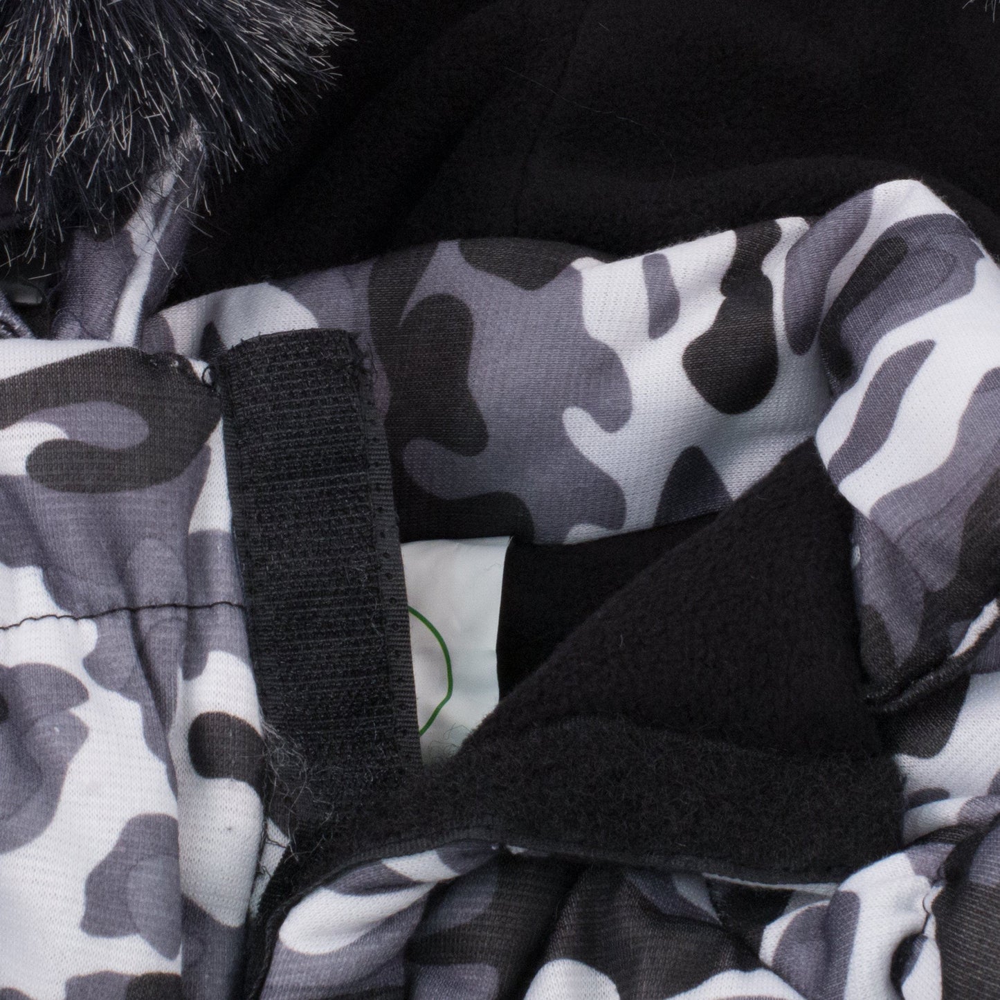 Close-up of a camouflage-patterned fabric with black straps