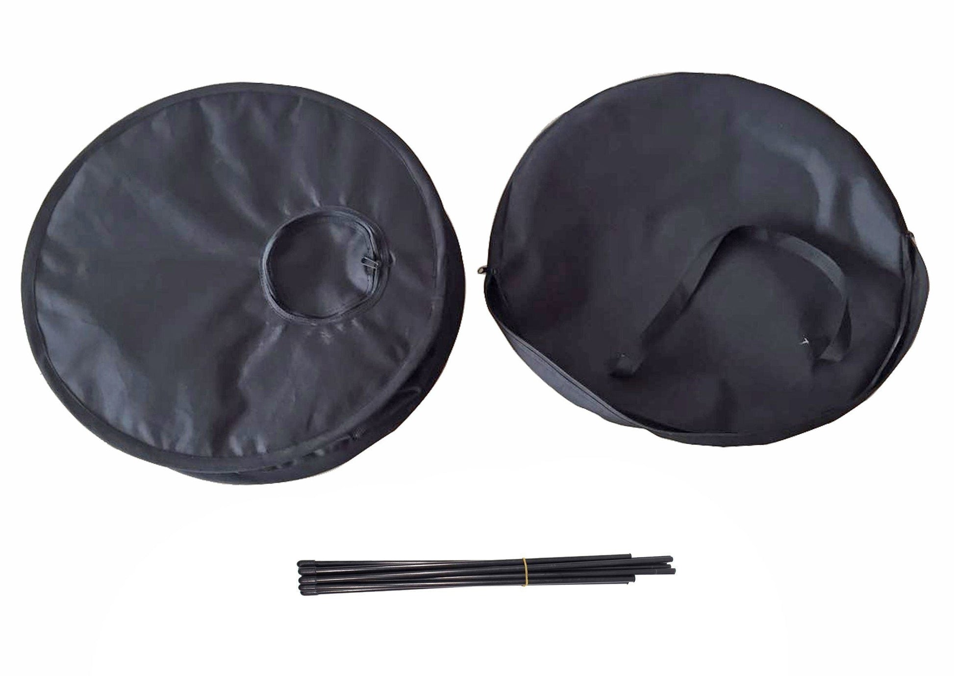 Two black round covers with a central hole and three black sticks on a white background