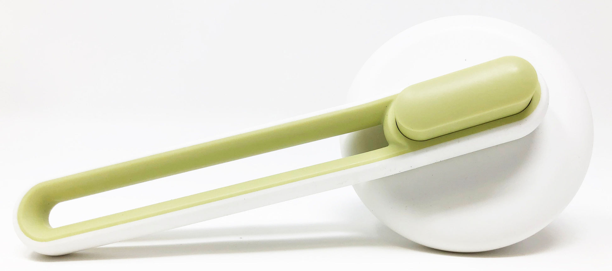 Green and white deshedding tool on a white background