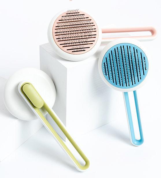 Three handheld cleaning brushes with different colored handles on a white background
