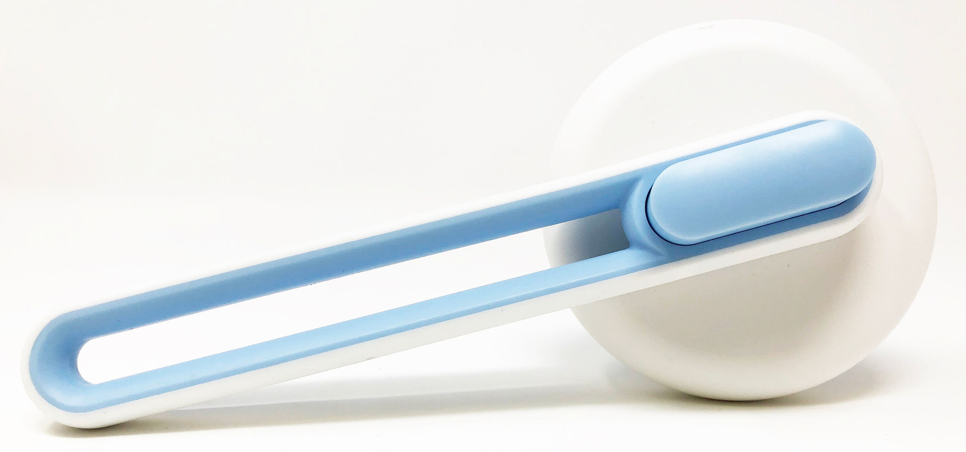 White and blue grooming tool on a white background