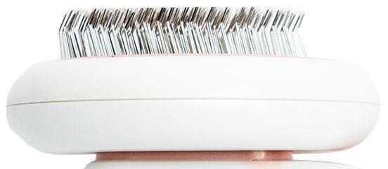 White electronic device with metallic bristle-like components on a white background