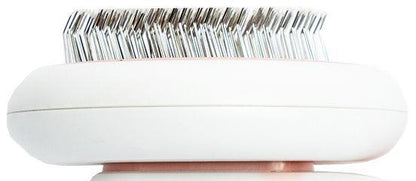 White electronic device with metallic bristle-like components on a white background