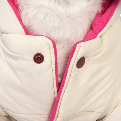 Close-up of a beige coat with pink trim and brown buttons on a light background
