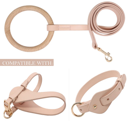 Set of pink leather dog accessories including a leash, collar, and harness on a white background.