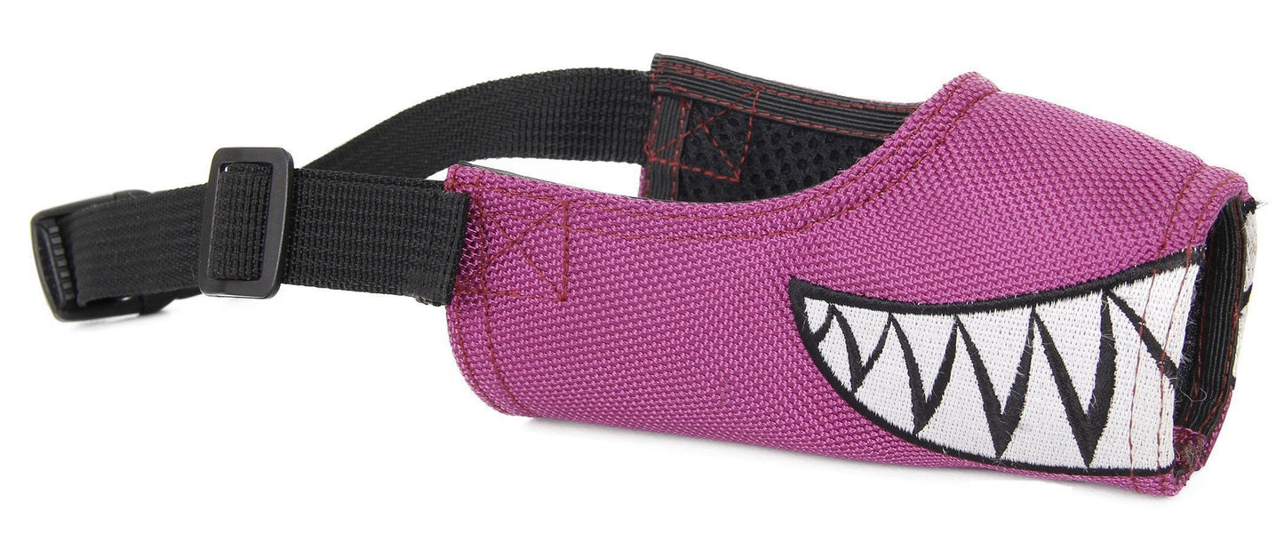 Pink dog muzzle with black strap and cartoonish mouth design on a white background