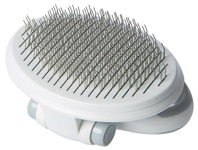 White grooming brush with metal bristles on a white background