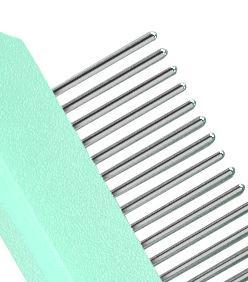 Metal hair comb on a light green background