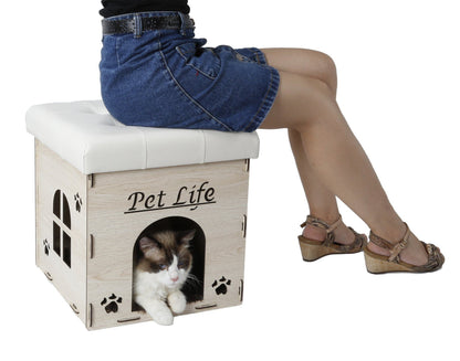 Person sitting on a 'Pet Life' cat house with a cat inside, on a white background
