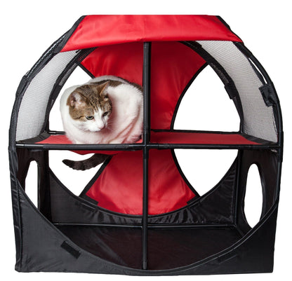 Cat inside a red and black pet playpen on a white background