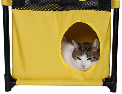 Cat peeking out from a yellow pet playpen with black mesh
