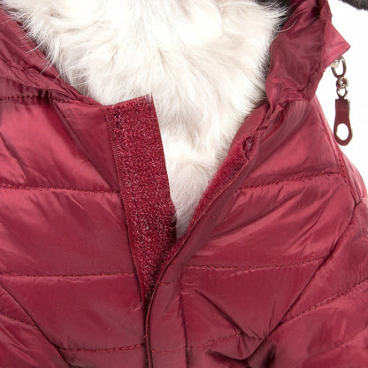 Close-up of a red puffer jacket with white fur lining on a white background