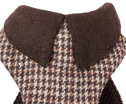 Close-up of a houndstooth patterned fabric with a brown collar on a white background