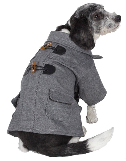 Dog wearing a gray coat with button details on a white background