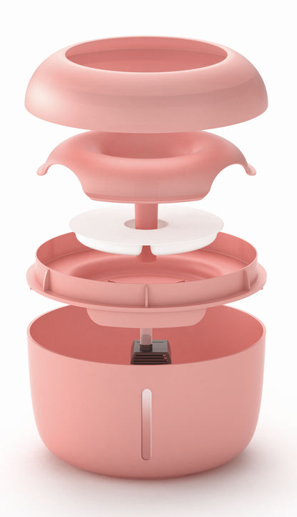 Pink kitchen appliance with multiple components on a white background
