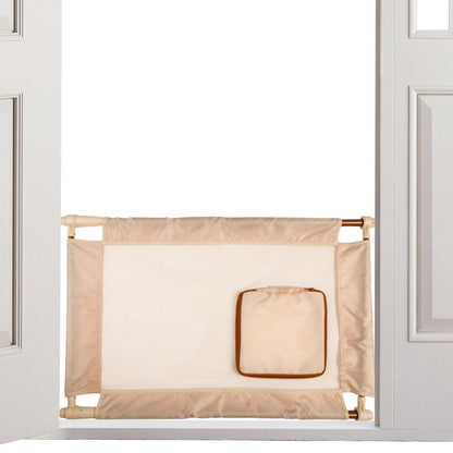 Beige baby gate with a small square mirror attached, placed between two white doors.
