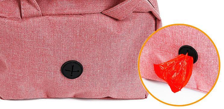 Close-up of a pink bag with a black button and a red tag on a white background