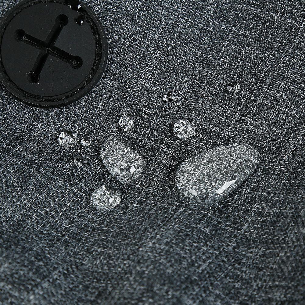 Close-up of a textured gray fabric surface with a black button featuring a star design.