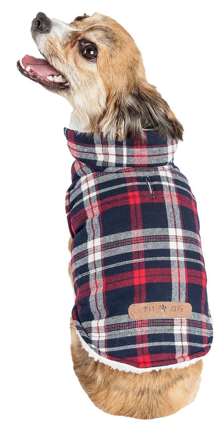 Dog wearing a plaid coat with a visible brand label on a white background