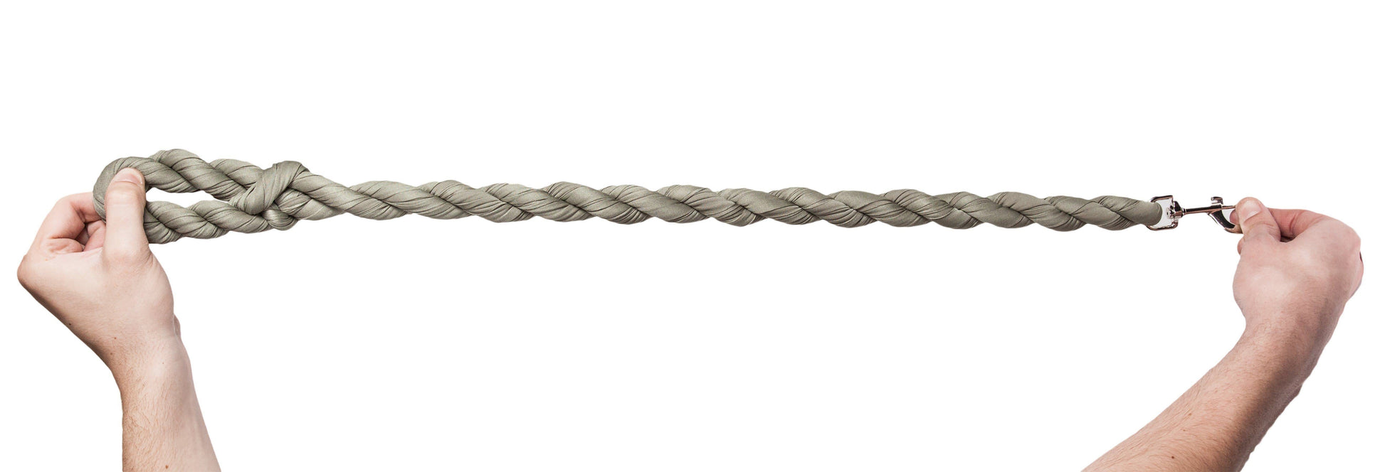 Two hands holding a long braided rope against a white background