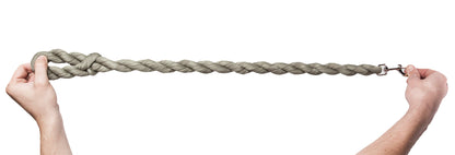 Two hands holding a long braided rope against a white background