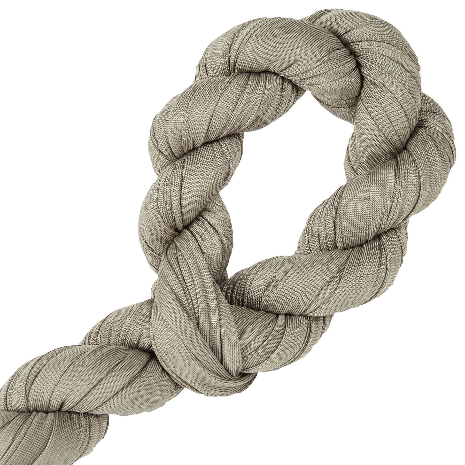 Coiled beige rope on a white background