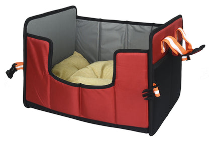 Red pet travel crate with a cushion inside on a white background