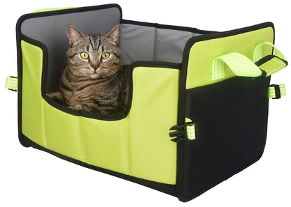 Cat sitting inside a green and black pet carrier on a white background