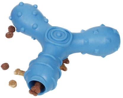 Blue dog toy with a central hole containing small treats on a white background