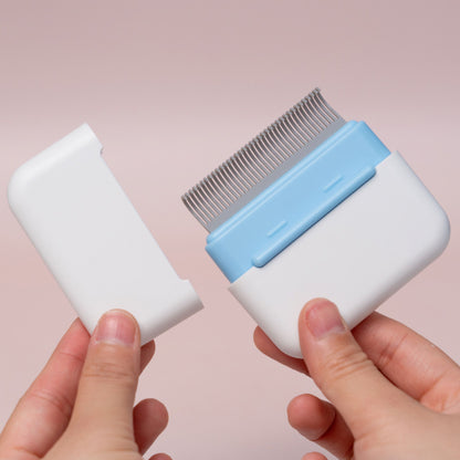 Pet grooming comb with a clear plastic top on a pink background