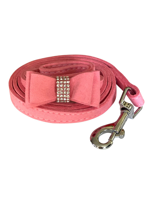 Pink dog leash with a bow and rhinestones on a white background