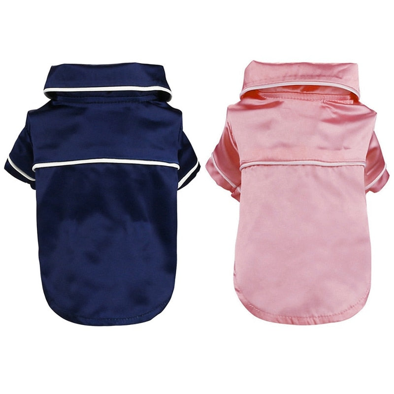 Navy and pink dog raincoats on a white background