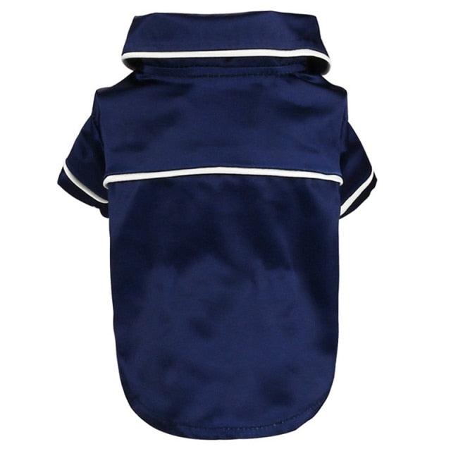 Navy blue dog raincoat with white trim on a white background