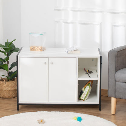 White storage cabinet with doors in a room with a plant and gray sofa.