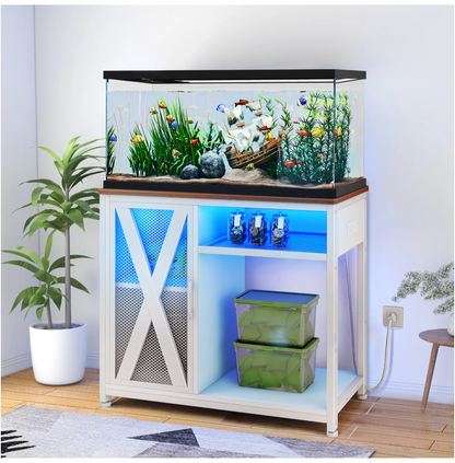 Fish tank with plants and fish on a wooden stand in a room setting.