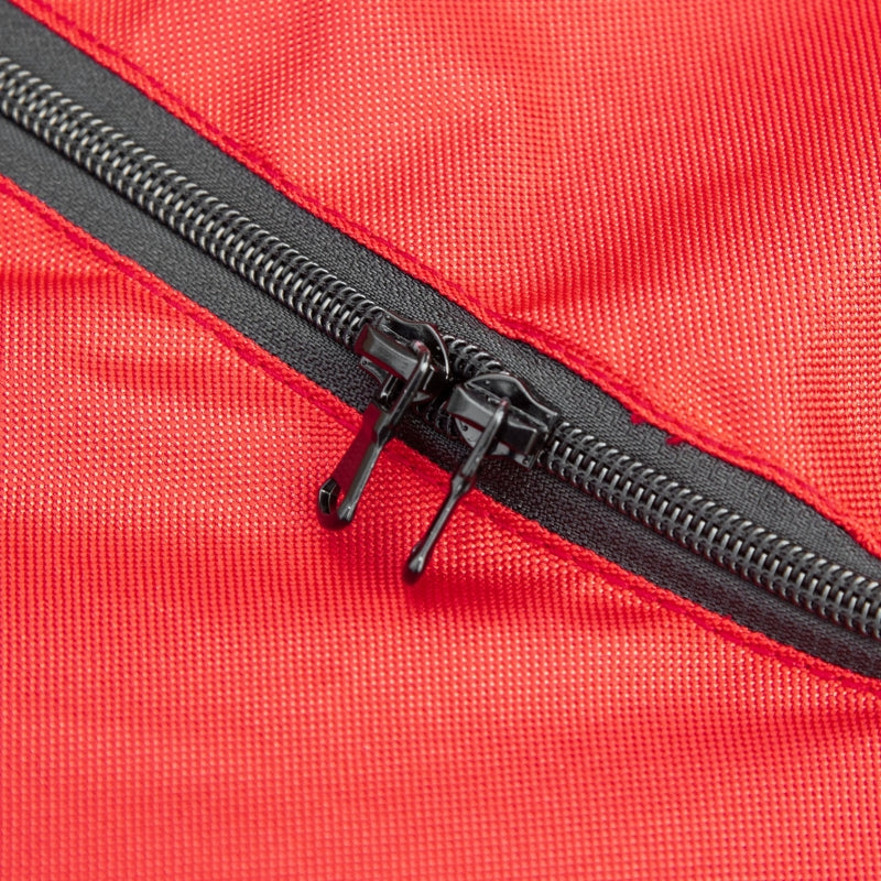 Close-up of a red bag with a black zipper